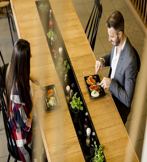 Young loving couple having lunch in the modern restaurant