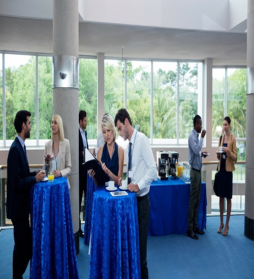 Business executives interacting with each other while having coffee at conference center